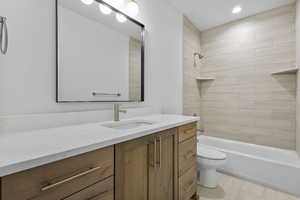 Full bath with vanity, washtub / shower combination, and recessed lighting