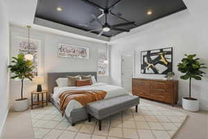 Enhanced stagingBedroom with light carpet, a tray ceiling, a ceiling fan, and recessed lighting