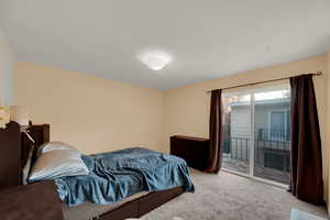 Bedroom featuring carpet floors and access to exterior