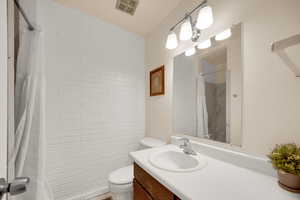 Bathroom with vanity and a shower with shower curtain