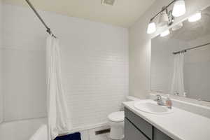 Bathroom with vanity, light tile patterned floors, and shower / bath combination with curtain