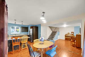 Dining space featuring stairway and light wood-style flooring