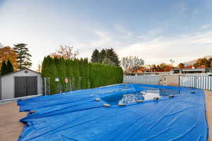 Community pool with a storage shed and a deck
