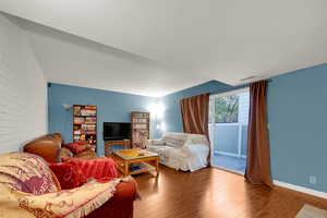 Living area with wood finished floors and baseboards