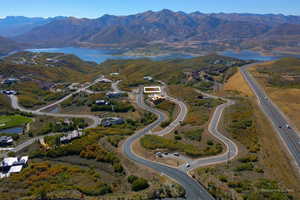 Aerial view of property and surrounding area featuring a water and mountain view