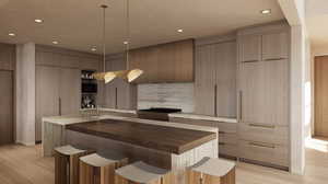 Kitchen with modern cabinets, wood counters, a breakfast bar area, and recessed lighting