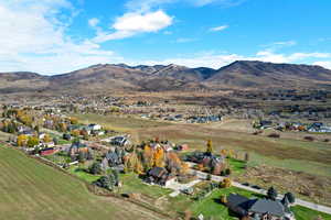 Aerial view of property's location featuring a mountainous background