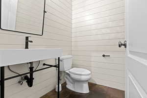 Half bath with wooden walls, modern cottage finishes and slate floors