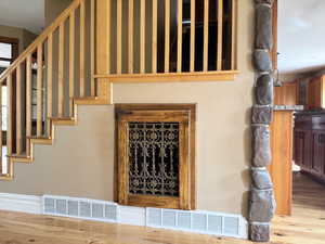 Staircase featuring built-in, custom dog crate