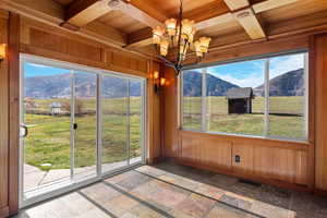 Dining room with Nordic Valley Resort views, coffered ceiling with custom mill work, and a chandelier