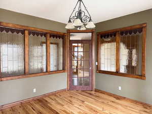 Unfurnished office with custom interior glass windows and wood floors