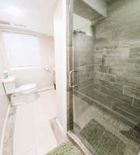 Full bathroom with vanity, a stall shower, and tile patterned floors