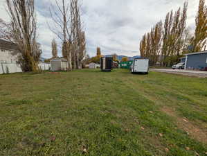 View of yard with a storage shed