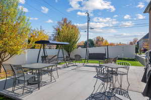 Fenced backyard with outdoor dining area and a patio
