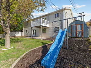 Rear view of house featuring a storage unit, a patio, and french doors