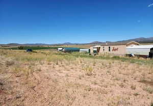 View of yard featuring a mountain view and a view of countryside