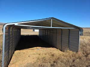 View of outbuilding with a detached carport