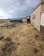 View of yard with an outbuilding and a rural view
