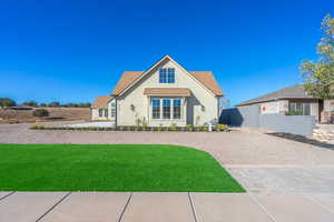 View of front of house featuring stucco siding, a shingled roof, and driveway