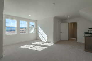 Bonus room with light carpet and recessed lighting