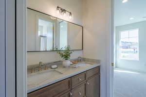 Bathroom featuring double vanity, carpet, recessed lighting, and curtained shower