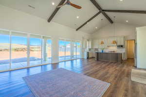 Living room featuring high vaulted ceiling, beam ceiling, ceiling fan, dark wood finished floors, and recessed lighting