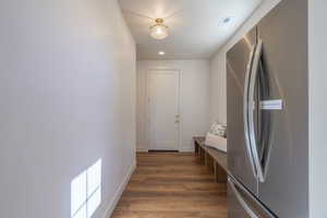 Interior space with freestanding refrigerator, dark wood finished floors, and recessed lighting