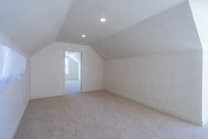 Bonus room featuring light colored carpet, lofted ceiling, and recessed lighting