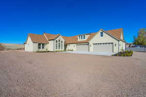 Traditional home with concrete driveway, stucco siding, and a shingled roof