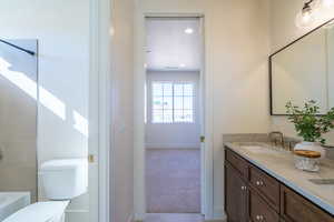 Full bath with shower / tub combination, double vanity, light colored carpet, and recessed lighting