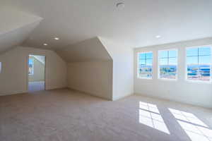 Bonus room featuring light colored carpet, vaulted ceiling, and recessed lighting