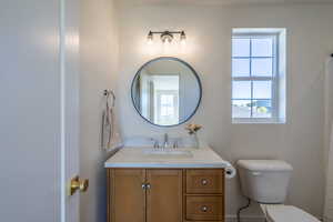 Bathroom featuring plenty of natural light, vanity, and a shower with shower curtain