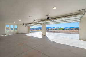 Garage with a mountain view and a garage door opener