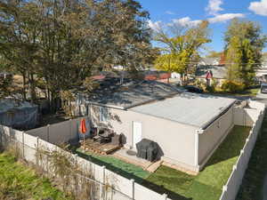 View of property exterior featuring a fenced backyard and a wooden deck