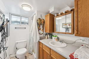 Full bath featuring curtained shower, vanity, and light tile patterned floors