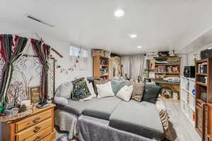 Bedroom featuring wood finished floors, recessed lighting, and a textured ceiling