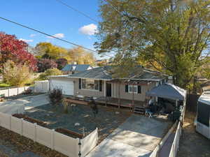 View of front of home featuring a fenced front yard, driveway, and a gazebo