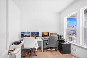 Home office with light colored carpet