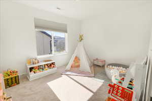 Rec room featuring carpet and baseboards