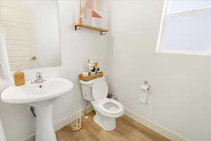 Bathroom with wood finished floors and baseboards