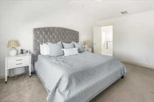 Bedroom with light carpet and baseboards