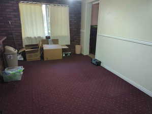 Interior space with carpet flooring and baseboards