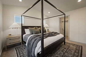 Bedroom featuring dark colored carpet, recessed lighting, and lofted ceiling