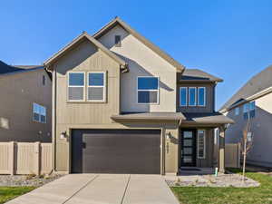 View of front facade featuring an attached garage and concrete driveway