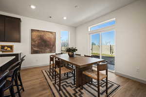 Dining space with light wood-style flooring, recessed lighting, and plenty of natural light