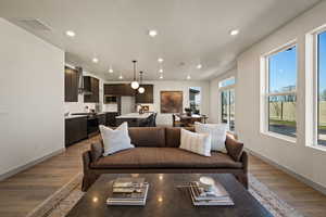 Living area with dark wood-type flooring and recessed lighting