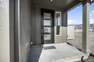 Doorway to property featuring a mountain view and board and batten siding