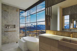 Full bath featuring a freestanding tub, a mountain view, a tile shower, vanity, and a wall of windows