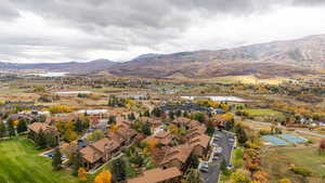 Aerial overview of property's location with a water and mountain view and nearby suburban area