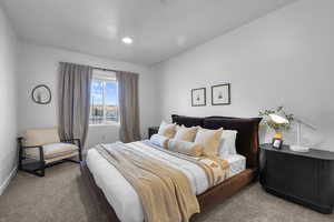 Bedroom featuring carpet flooring and baseboards